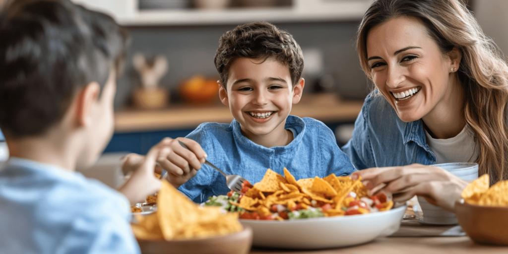Alt Text: Family enjoying Frito Taco Salad at dinner

